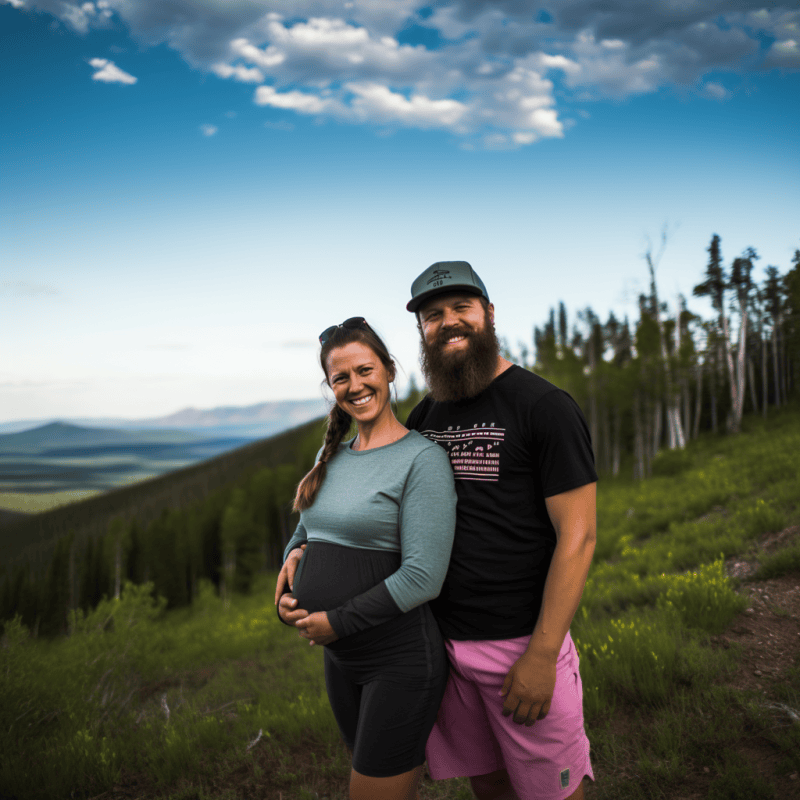 pregnant woman and her husband on a hike before the baby comes