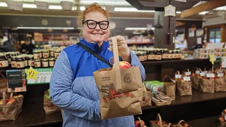 Heather holding a bag of apples